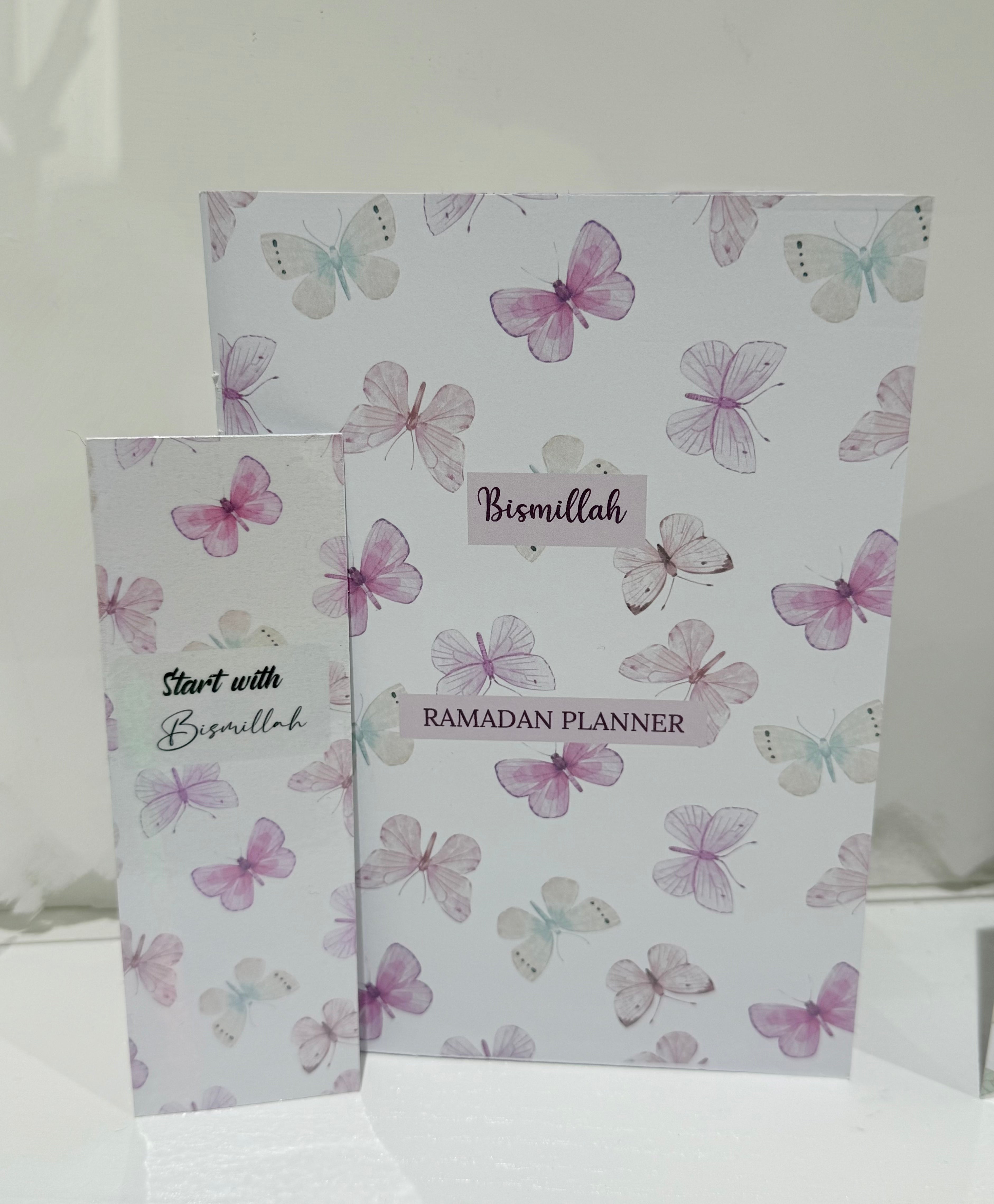 Two planners with butterfly design and 'Bismillah' text on a white background