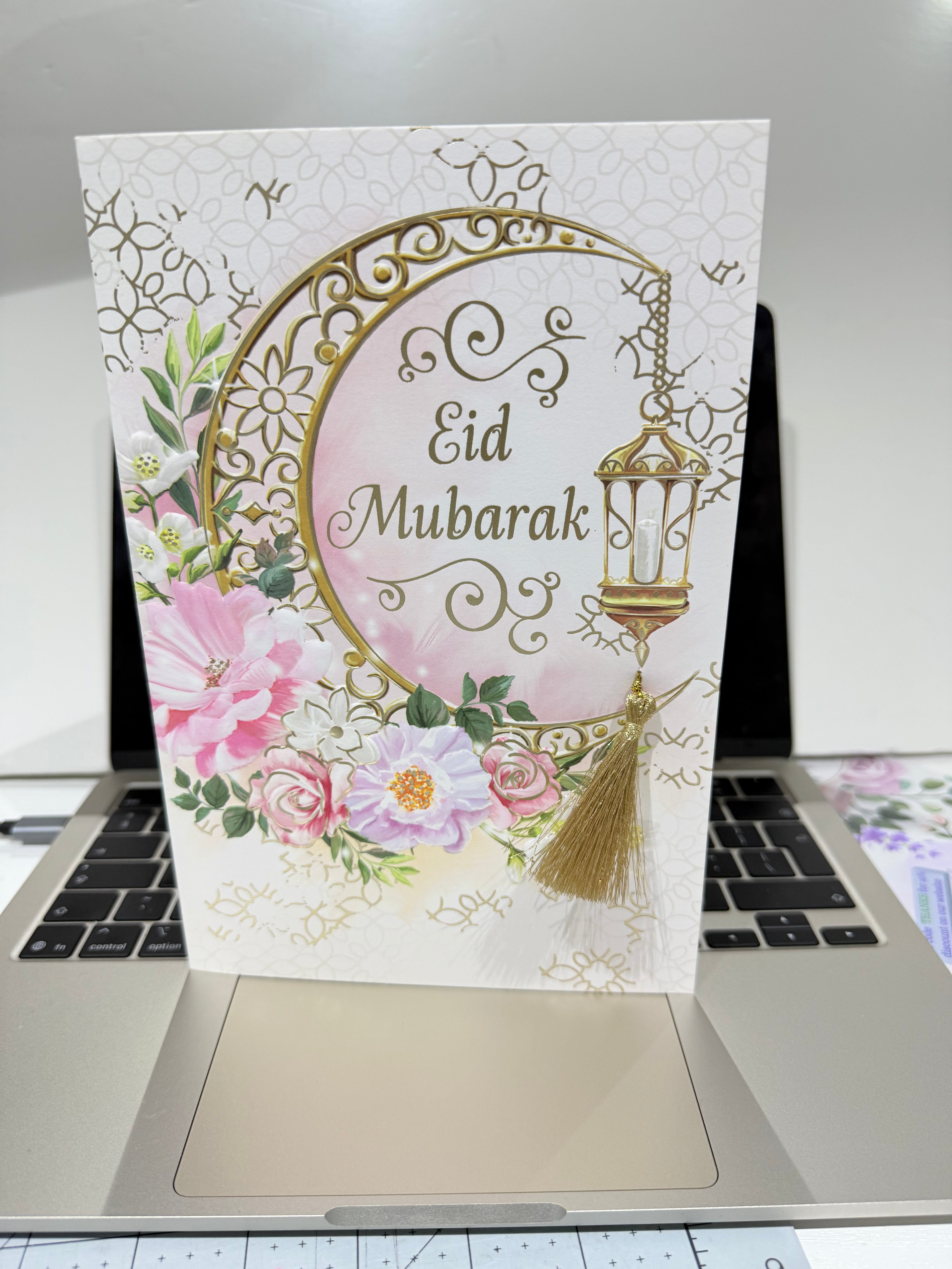 Eid Mubarak card with floral design on a laptop