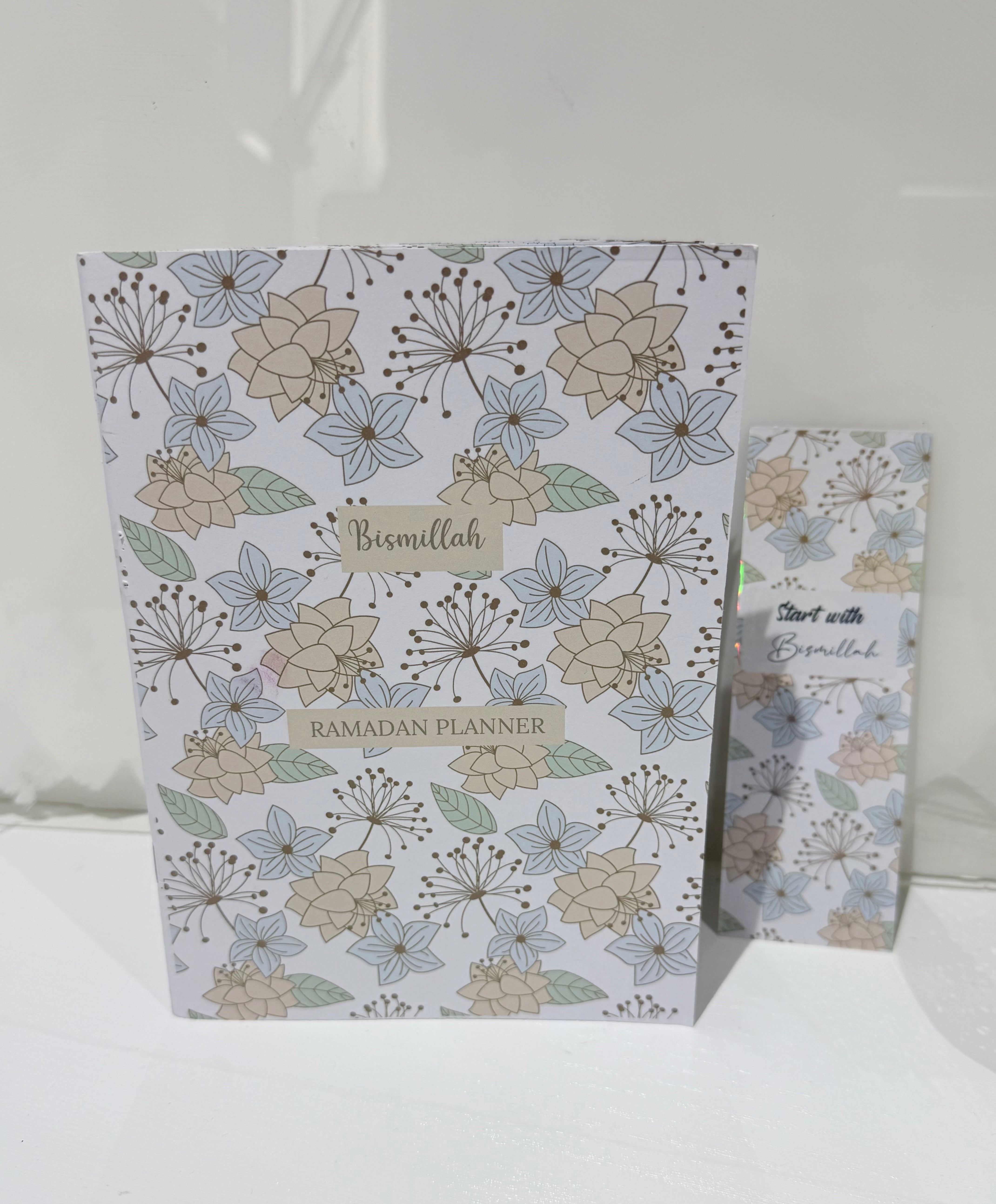 Floral-patterned planner with 'Bismillah' and 'Ramadan Planner' text on a white background