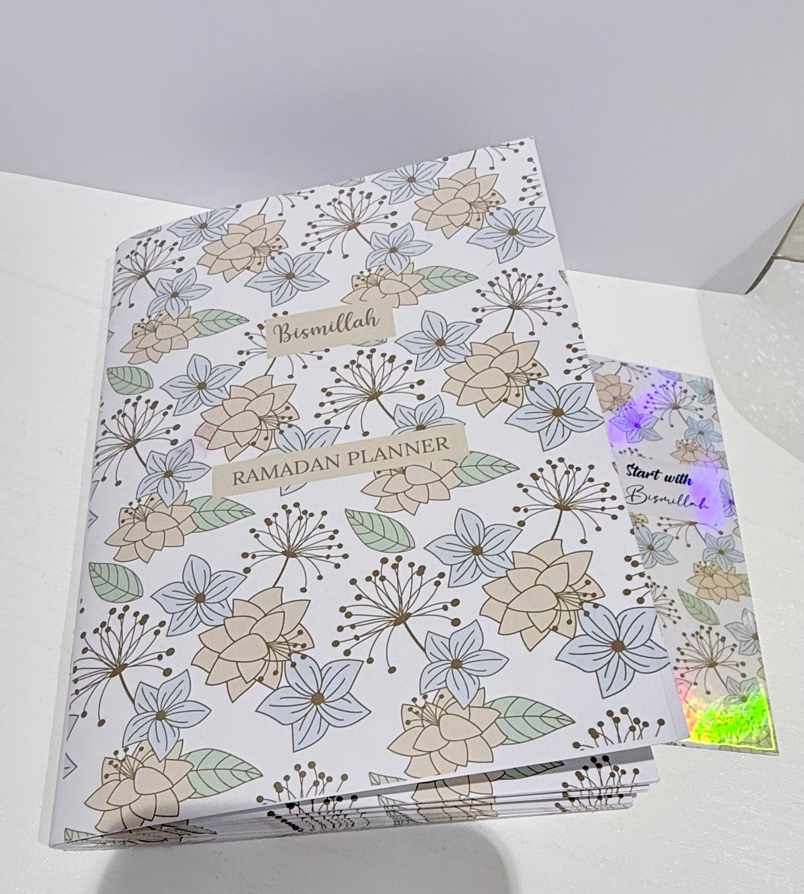 Floral-patterned Ramadan planner on a white surface