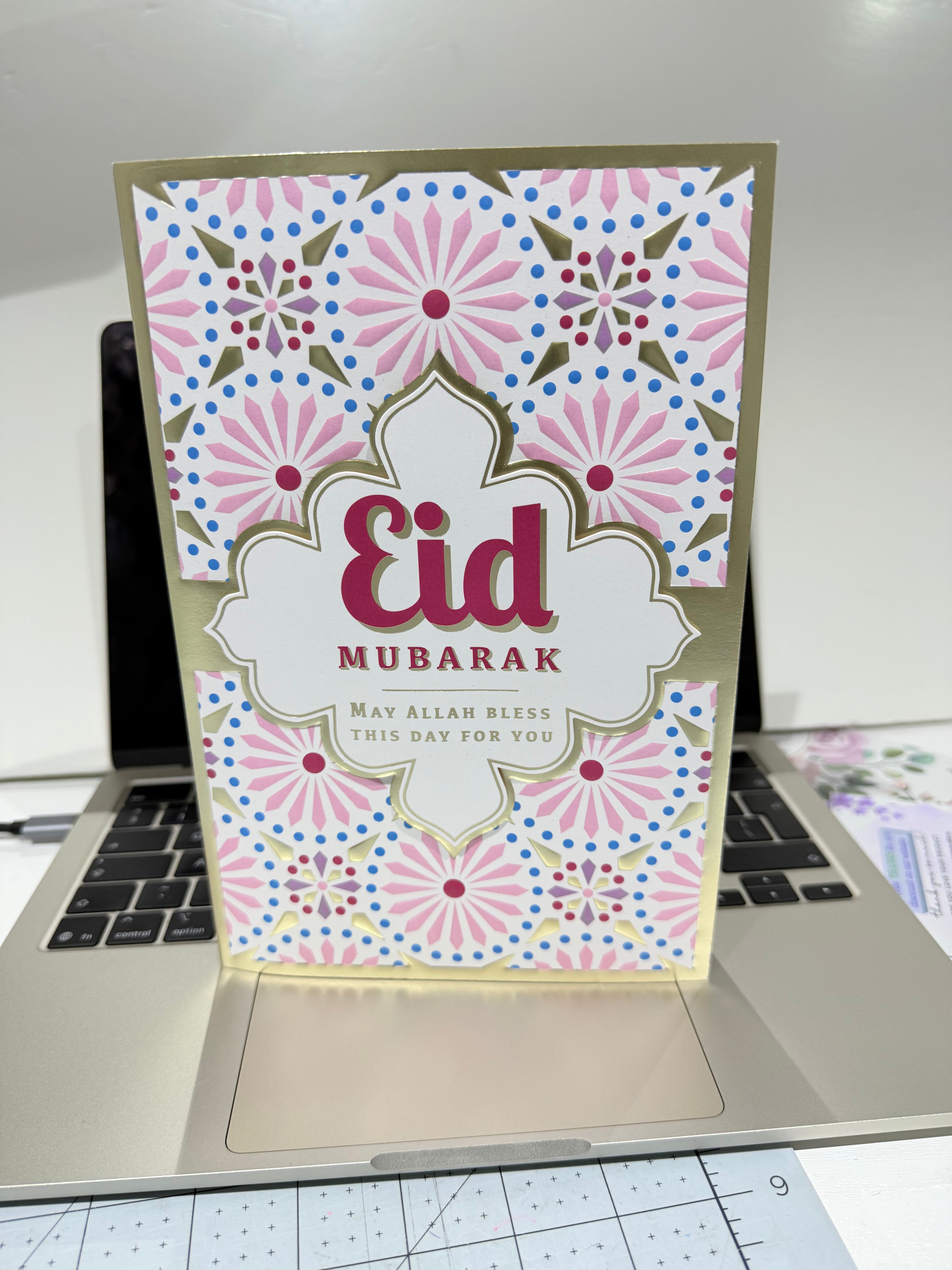 Eid Mubarak card with floral design on a laptop
